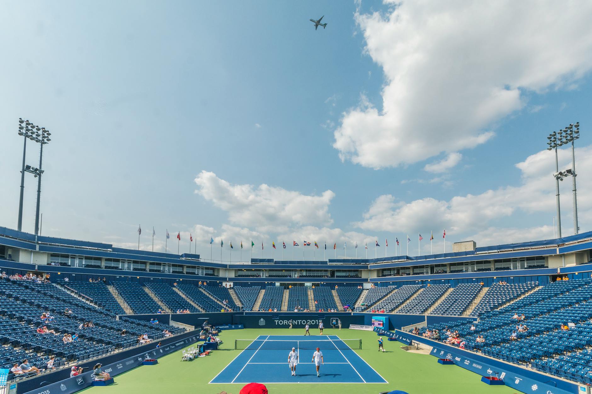 people standing on blue and green tennis court 2036 Olympics